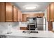 Bright kitchen features stainless steel appliances, a modern faucet, and a lovely white countertop at 4855 Edison Ave # 112, Boulder, CO 80301