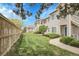 Serene backyard featuring a lush green lawn, privacy fence, and neatly trimmed bushes at 8475 Pebble Creek Way # 204, Highlands Ranch, CO 80126
