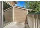 View of the balcony space with sliding glass door, tan siding, and metal railing at 8475 Pebble Creek Way # 204, Highlands Ranch, CO 80126
