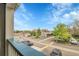 Balcony view with community parking, carports and landscaping under a beautiful blue sky at 8475 Pebble Creek Way # 204, Highlands Ranch, CO 80126