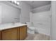 Clean bathroom featuring a wood vanity, white fixtures, and tile flooring at 8475 Pebble Creek Way # 204, Highlands Ranch, CO 80126