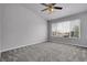 Bedroom with carpet and large window overlooking the neighborhood at 8475 Pebble Creek Way # 204, Highlands Ranch, CO 80126
