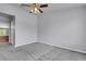Bedroom with carpet and ceiling fan. Bathroom can be seen through the doorway at 8475 Pebble Creek Way # 204, Highlands Ranch, CO 80126