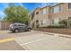 Tan apartment building with a car in the parking lot, and a stairway to the second floor at 8475 Pebble Creek Way # 204, Highlands Ranch, CO 80126