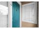 Stylish teal-colored front door with a decorative knocker and prominent unit number at 8475 Pebble Creek Way # 204, Highlands Ranch, CO 80126