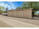 Row of garages under a blue sky with parked cars and trees in background at 8475 Pebble Creek Way # 204, Highlands Ranch, CO 80126