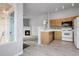 Open-concept living space with wood-look floors, a cozy fireplace, and modern lighting at 8475 Pebble Creek Way # 204, Highlands Ranch, CO 80126