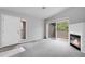 Bright living room with plush carpeting, fireplace, and sliding doors leading to a private balcony at 8475 Pebble Creek Way # 204, Highlands Ranch, CO 80126