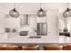 Modern kitchen features stainless steel appliances, pendant lighting, and a center island with seating at 4335 N Pecos St, Denver, CO 80211