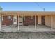 Covered brick back porch with concrete flooring, accessible from multiple doors and providing outdoor space at 2111 W 80Th Ave, Denver, CO 80221
