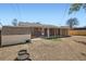 Spacious backyard featuring a brick home, covered patio, shed and a fenced yard at 2111 W 80Th Ave, Denver, CO 80221