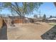 Large, empty backyard with a stone fire pit, surrounded by a wood fence, perfect for outdoor activities at 2111 W 80Th Ave, Denver, CO 80221