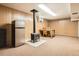 Finished basement featuring a wood-burning stove, fridge, and dining area for entertaining at 2111 W 80Th Ave, Denver, CO 80221