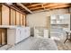 Unfinished basement area featuring exposed ceiling and walls with shelving for storage at 2111 W 80Th Ave, Denver, CO 80221