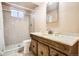 Classic bathroom featuring a tiled shower, tiled flooring, and wood vanity with sink at 2111 W 80Th Ave, Denver, CO 80221