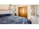 Bright bedroom featuring a cozy bed, neutral walls, and closet for ample storage at 2111 W 80Th Ave, Denver, CO 80221