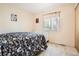 Comfortable bedroom featuring a cozy bed, large window, and bright neutral walls at 2111 W 80Th Ave, Denver, CO 80221