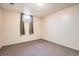 Finished basement features neutral walls, carpet flooring, and a bright window at 2111 W 80Th Ave, Denver, CO 80221