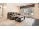 Bright living room with plush seating, neutral carpet, and lots of natural light at 2111 W 80Th Ave, Denver, CO 80221