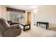 Cozy living room featuring plush furniture, a coffee table, and sliding glass door at 2111 W 80Th Ave, Denver, CO 80221
