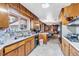 Kitchen with wood cabinets, and view into dining area at 1941 W 160Th Ave, Broomfield, CO 80023