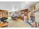 Spacious living area with a stone fireplace and adjacent kitchen at 1941 W 160Th Ave, Broomfield, CO 80023