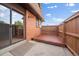 Backyard patio with sliding glass doors and a wooden privacy fence at 14735 W Ellsworth Ave, Golden, CO 80401
