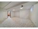 Spacious basement with neutral carpet, bright lighting, and ample room for storage at 14735 W Ellsworth Ave, Golden, CO 80401