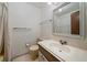 Bathroom sink and mirror, alongside a toilet and shower with curtains at 14735 W Ellsworth Ave, Golden, CO 80401