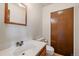 Clean bathroom with a white sink, wood-framed mirror, and a spacious closet at 14735 W Ellsworth Ave, Golden, CO 80401