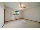 Spacious main bedroom features a ceiling fan, neutral decor, a large window, and carpeted floors at 14735 W Ellsworth Ave, Golden, CO 80401