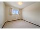 Well-lit bedroom with a window and neutral carpeting at 14735 W Ellsworth Ave, Golden, CO 80401