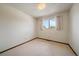 Simple bedroom with a window view and neutral-toned carpet at 14735 W Ellsworth Ave, Golden, CO 80401