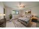 Inviting main bedroom features a ceiling fan, neutral decor, a large window, and carpeted floors at 14735 W Ellsworth Ave, Golden, CO 80401