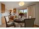 Dining area featuring a stylish table setting near a kitchen, complemented by natural light from the sliding glass door at 14735 W Ellsworth Ave, Golden, CO 80401