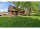 Charming townhome community with lush green lawn and mature trees at 14735 W Ellsworth Ave, Golden, CO 80401