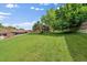 Well-maintained lawn area with mature trees providing shade and a view of the community buildings at 14735 W Ellsworth Ave, Golden, CO 80401