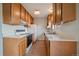 Functional kitchen with a refrigerator, range, double sink, and ample cabinetry at 14735 W Ellsworth Ave, Golden, CO 80401