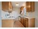 Functional kitchen features white countertops and wood cabinets, providing ample storage at 14735 W Ellsworth Ave, Golden, CO 80401