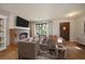 Comfortable living room with modern furnishings, a brick fireplace, and a large window at 14735 W Ellsworth Ave, Golden, CO 80401