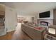 Cozy living room with a brick fireplace, modern furniture, and an open layout to the dining area at 14735 W Ellsworth Ave, Golden, CO 80401