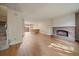 Inviting living room with a brick fireplace, hardwood floors, and an open staircase for a modern feel at 14735 W Ellsworth Ave, Golden, CO 80401