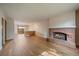 Bright living room featuring hardwood floors, a brick fireplace, and a sliding door to outdoor space at 14735 W Ellsworth Ave, Golden, CO 80401