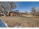 Large backyard with mature trees and room for outdoor activities at 6032 Estes St, Arvada, CO 80004