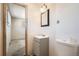 This bathroom features a vanity, mirror, toilet, and neutral walls at 6032 Estes St, Arvada, CO 80004