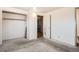 This bedroom features a closet with rod, overhead lighting, and neutral walls at 6032 Estes St, Arvada, CO 80004