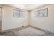 This bedroom features two windows, and neutral walls, providing a blank canvas for customization at 6032 Estes St, Arvada, CO 80004