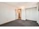 This bedroom features overhead lighting and an open doorway at 6032 Estes St, Arvada, CO 80004