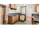 Functional kitchen featuring wood cabinets, laminate counters, and room for appliances at 6032 Estes St, Arvada, CO 80004