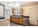 Bright kitchen featuring wooden cabinets, stainless steel appliances, laminate countertops, and a dual basin sink at 6032 Estes St, Arvada, CO 80004